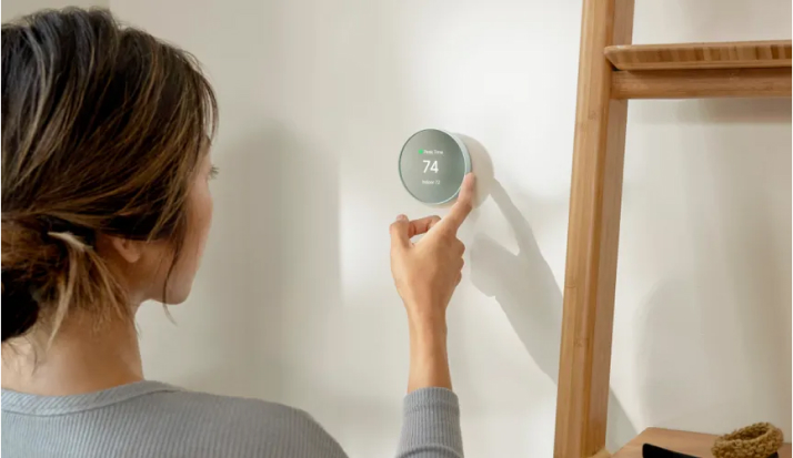 Person adjusting thermostat